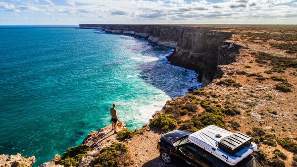 A man overlooks dramatic cliffs on the Australian coast