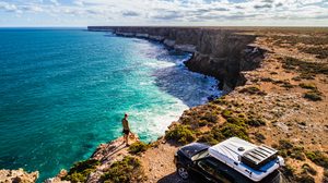 A man overlooks dramatic cliffs on the Australian coast