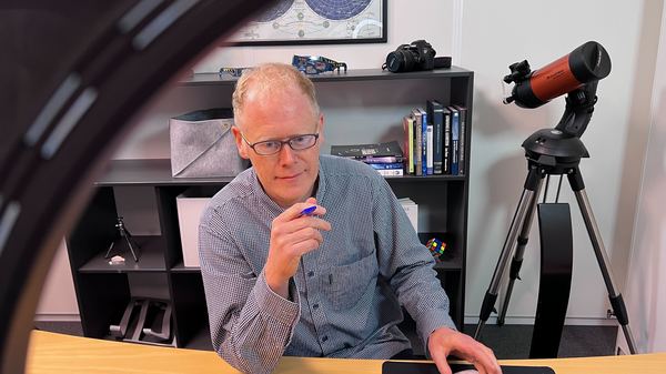 Streamer sitting in small studio, picture through ringlight