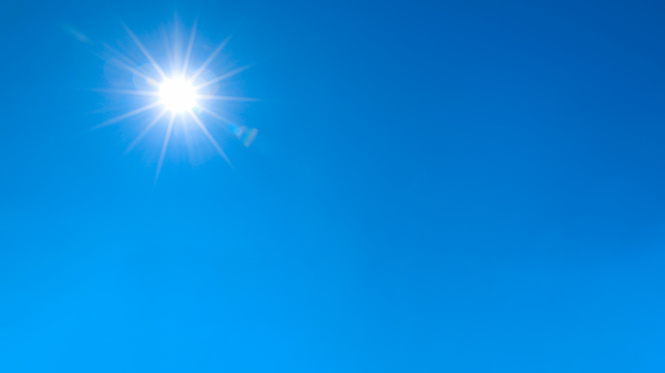 Image of bright Sun in blue sky.