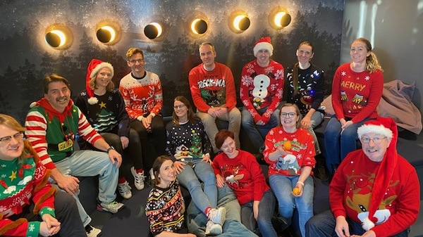 Employees at timeanddate.com dressed up in ugly Christmas sweaters.